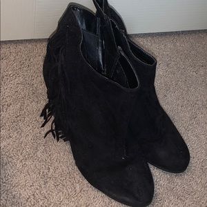 Black suede booties with fringe on the side